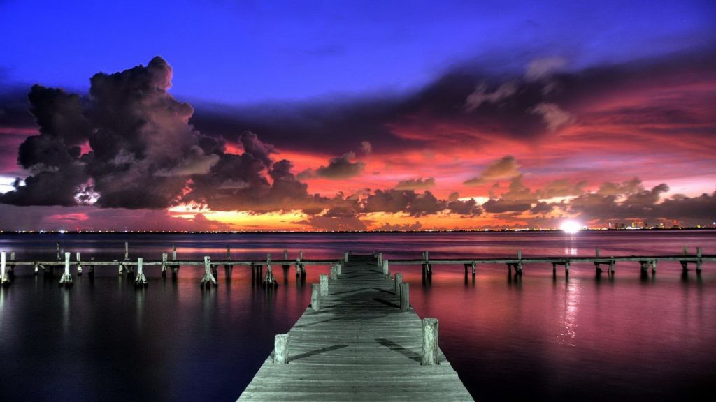 ocean dock sunset pink sky with clouds