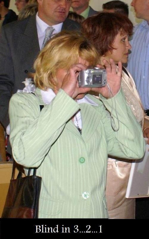Going Blind - lady holding camera backwards - funny caption photo