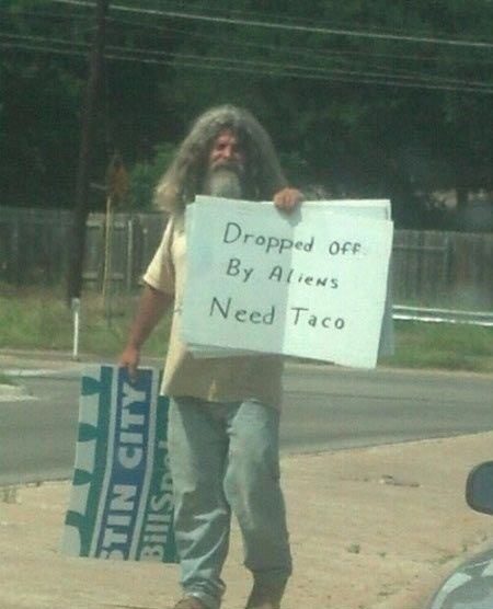 Dropped Off By Aliens - Funny Photo - homeless guy holding funny sign