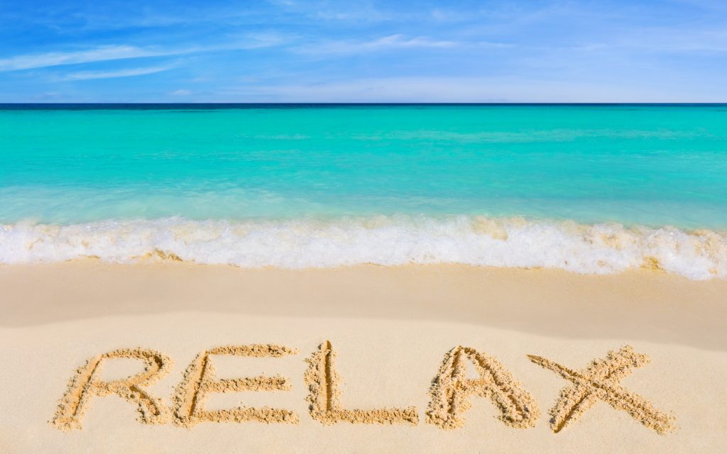Beach Wallpaper with "Relax" written in the sand
