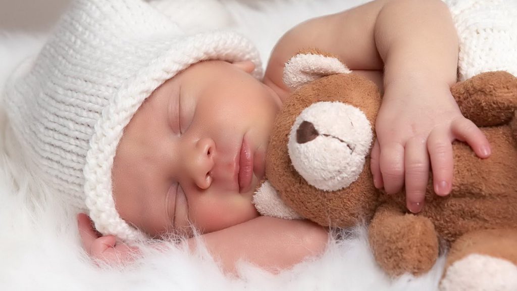 Baby Snuggling A Teddy Bear - Cute Wallpaper