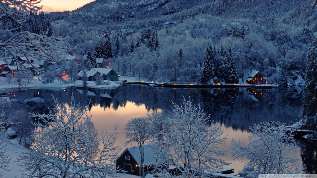 The Winter Lake Wallpaper - a frozen lake in the winter, snow covered homes in a mountain valley.